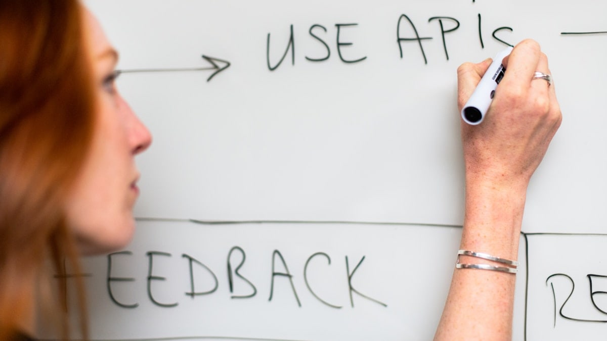 Female software engineer uses whiteboard